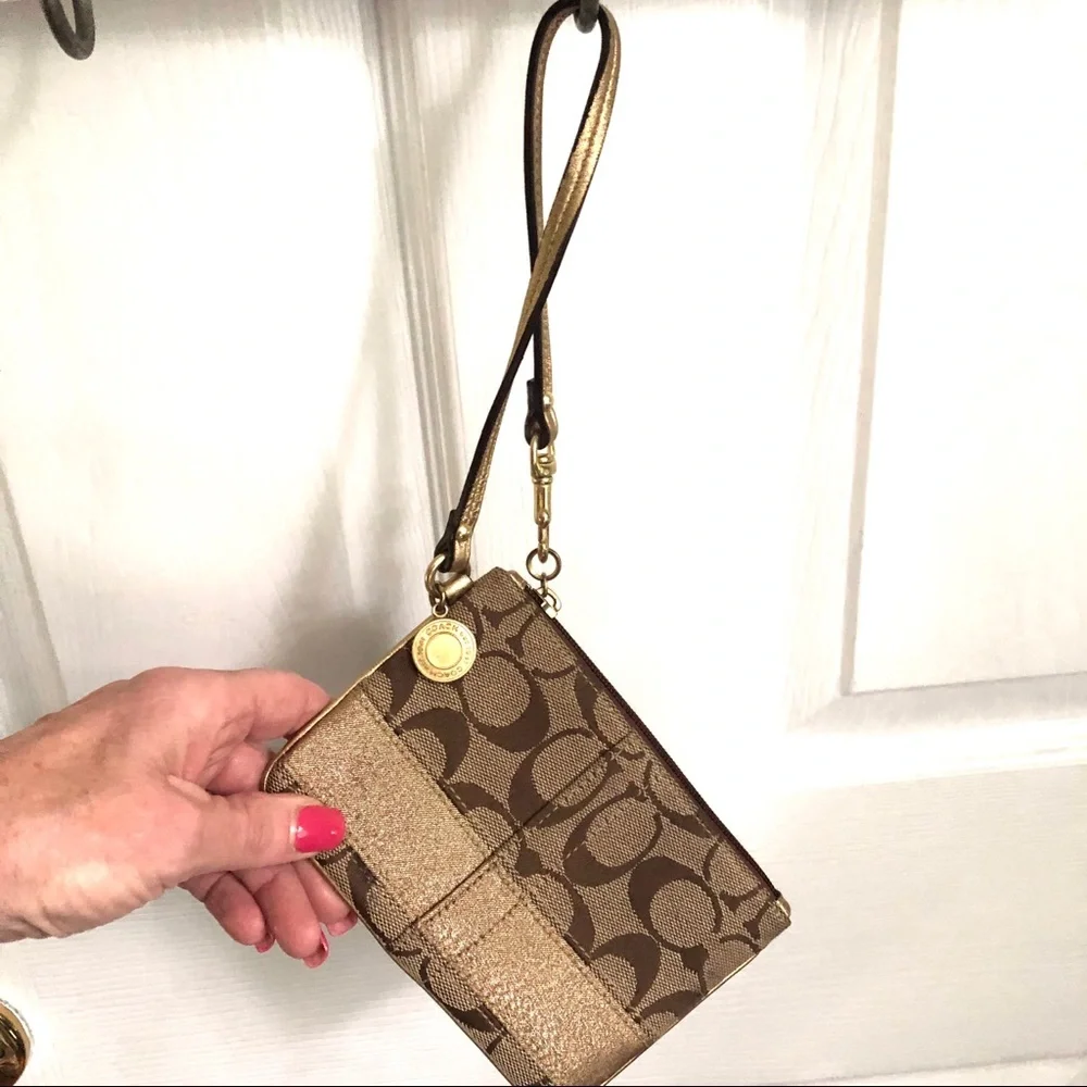 Coach signature tan wristlet, gold strap & stripe